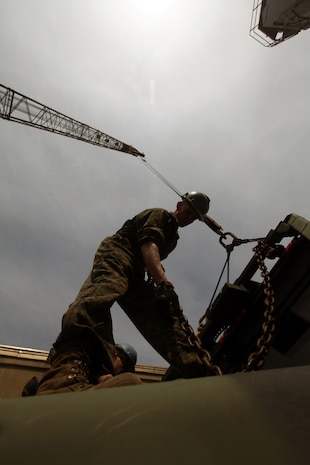 Lance Cpl. Anthony Stonebrook, a rifleman with Battalion Landing Team 1st Battalion, 2nd Marine Regiment, 24th Marine Expeditionary Unit, who is currently assigned to Combat Cargo, prepares a 7-ton truck for transportation onto the USS Gunston Hall March 28, 2012. The 24th MEU, partnered with the Navy's Iwo Jima Amphibious Ready Group, is deploying to the European and Central Command theaters of operation to serve as a theater reserve and crisis response force capable of a variety of missions from full-scale combat operations to humanitarian assistance and disaster relief. (Official Marine Corps Photo by Sgt. Richard Blumenstein)