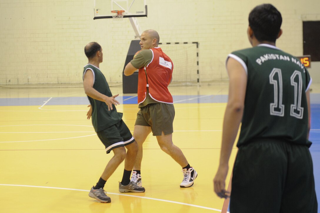 Sgt. Jordan C. Beaver, from Kelso, Washington, center, plays basketball here March 28. Beaver serves with Battalion Landing Team 3/1, the ground combat element for the 11th Marine Expeditionary Unit. The sporting event was hosted by the organizers of the Doha International Maritime Defense Exhibition and Conference (DIMDEX), and provided crews of other navies the opportunity to build camaraderie and strengthen established relationships. The unit is deployed as part of the Makin Island Amphibious Ready Group, a U.S. Central Command theater reserve force. The group is providing support for maritime security operations and theater security cooperation efforts in the U.S. 5th Fleet area of responsibility.