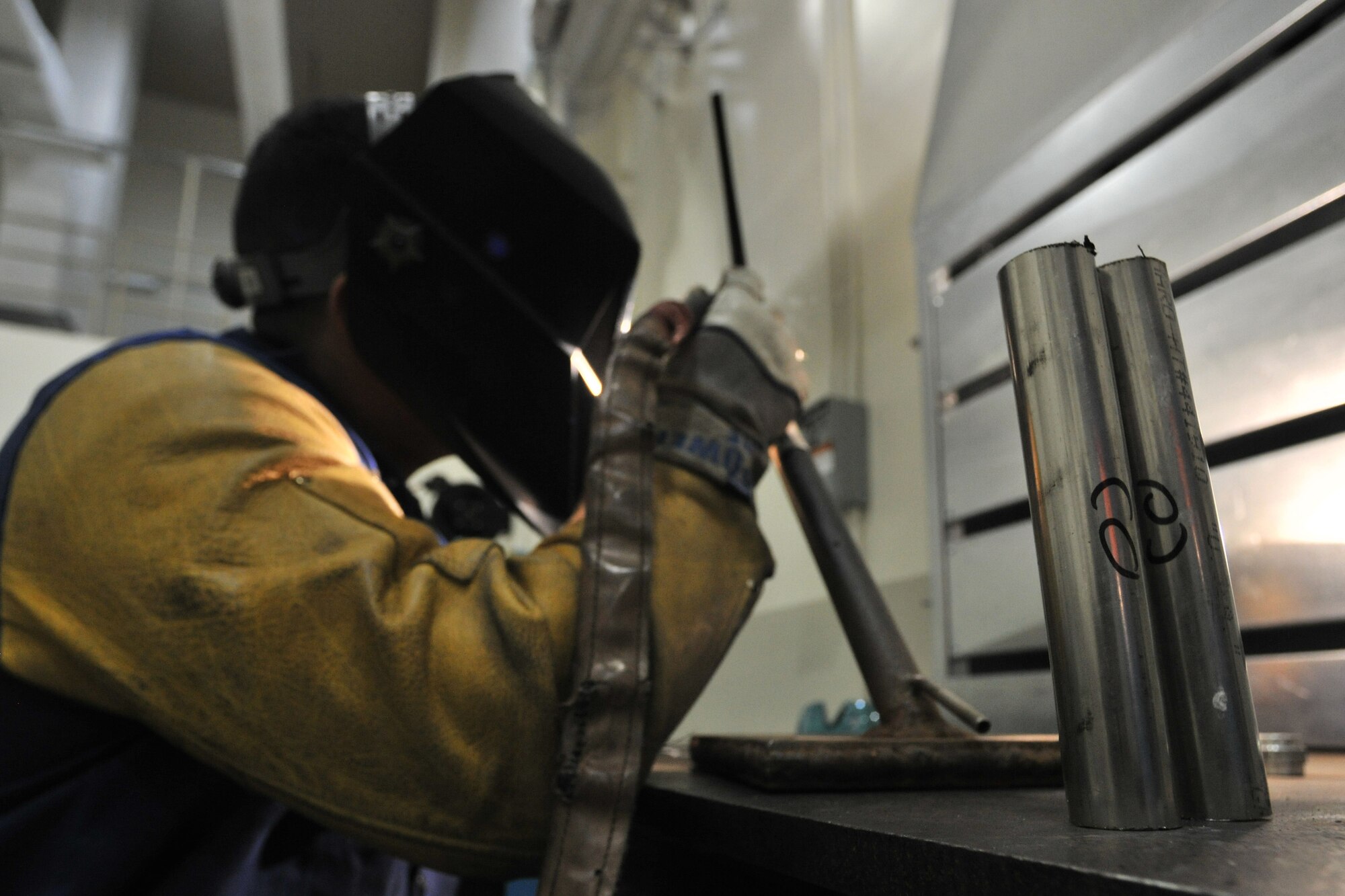 Senior Airman Jeffery Gaskins, 388th Expeditionary Maintenance Squadron aircraft metal technician, welds a piece of 6061 aluminum at Kunsan Air Base, Republic of Korea, March 29, 2012. Aircraft metal technicians design, weld, treat, and produce aircraft parts, while expertly handling precision tools, components, and assemblies for aerospace weapon systems and related support equipment. (U.S. Air Force photo/Senior Airman Brittany Y. Auld)