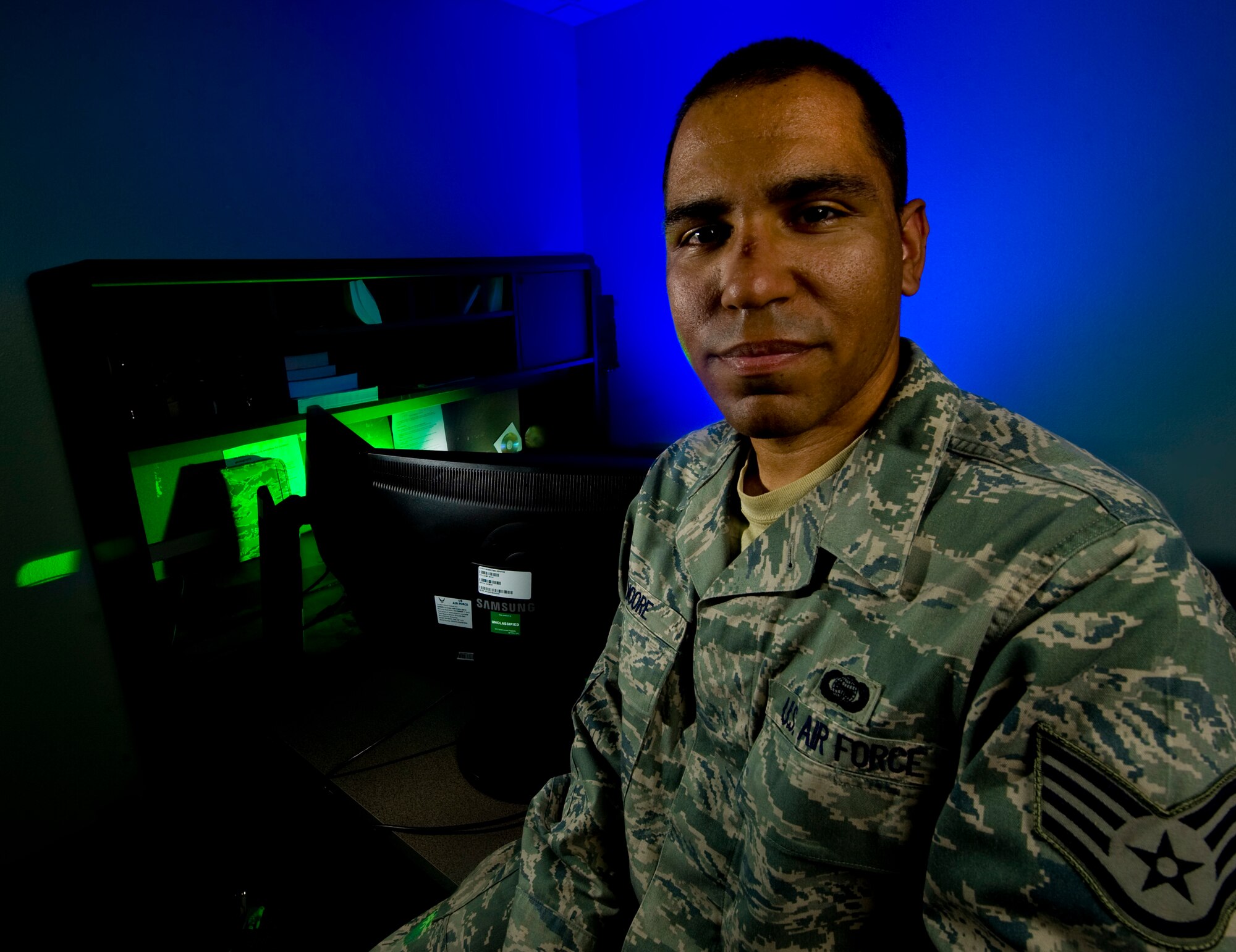 U.S. Air Force Staff. Sgt. James Moore, 57th Information Aggressor Squadron threat intelligence analyst journeyman, was presented the Excellence in Action award March 22, 2012, at Nellis Air Force Base, Nev. Moore, an Airman Leadership School John Levitow award winner, was recognized for compiling current enemy courses of action for 200 organizations weekly, setting up a safety day drunk driver simulation and volunteering at the base tax center. The award is presented monthly by the Nellis Chiefs' Group to an Airman who exhibits the highest levels of excellence, both on and off duty.  (U.S. Air Force photo by Airman 1st Class Daniel Hughes)

