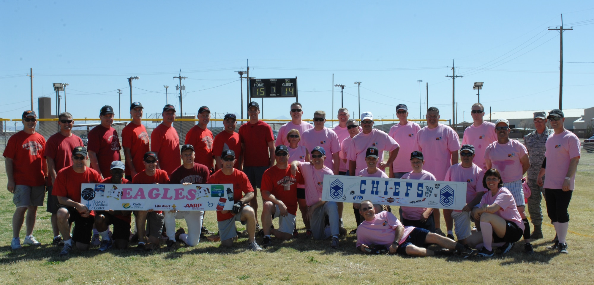 U.S. Air Force participants in the Chiefs vs. Eagles softball game hold their respective signs after the match at Thunderbolt Field on Davis-Monthan Air Force Base, Ariz., March 23.  The Chiefs were able to hold a slim 1-0 lead until the bottom of the third inning when the Eagles rallied to score three runs. The Eagles took the victory over the Chiefs, with the final score being 15-14. (U.S. Air Force photo by Airman 1st Class Saphfire Cook/Released)