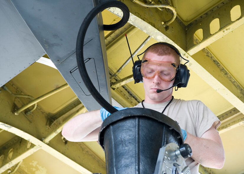 Staff Sgt. Jason Gibson, 2nd Aircraft Maintenance Squadron crew chief, drains hydraulic fluid from a B-52H Stratofortress hydraulic reservoir on Barksdale Air Force Base, La., March 28. Hydraulic fluid levels are one of the many items maintainers routinely inspect on the aircraft. (U.S. Air Force photo/Senior Airman Chad Warren)(RELEASED)