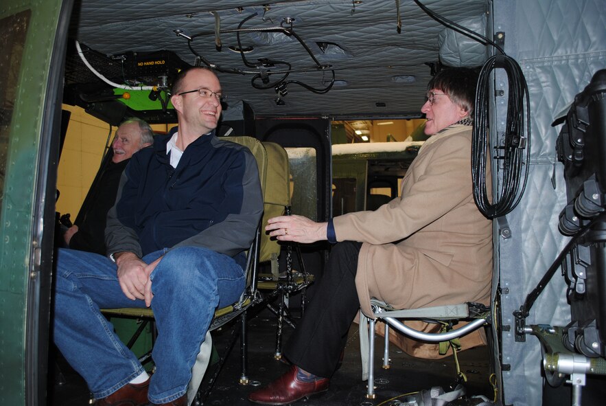 From left to right, Fred Burow, Great Falls city commissioner; Eric Bryson, Lewis and Clark County chief administrative officer; and William Bronson, city of Great Falls commissioner, get a closer look inside a UH-1N Huey helicopter during a tour of the base March 23. (U.S. Air Force photo/Airman 1st Class Katrina Heikkinen)