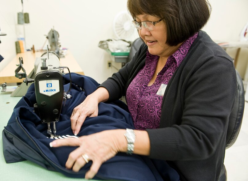 Tam Harper, Army & Air Force Exchange Service employee, sews senior master sergeant stripes onto a light-weight blues jacket on Barksdale Air Force Base, La., March 29. Harper has worked at Barksdale for 13 years, but has altered military uniforms around the world for 35 years. (U.S. Air Force photo/Senior Airman Chad Warren)(RELEASED)
