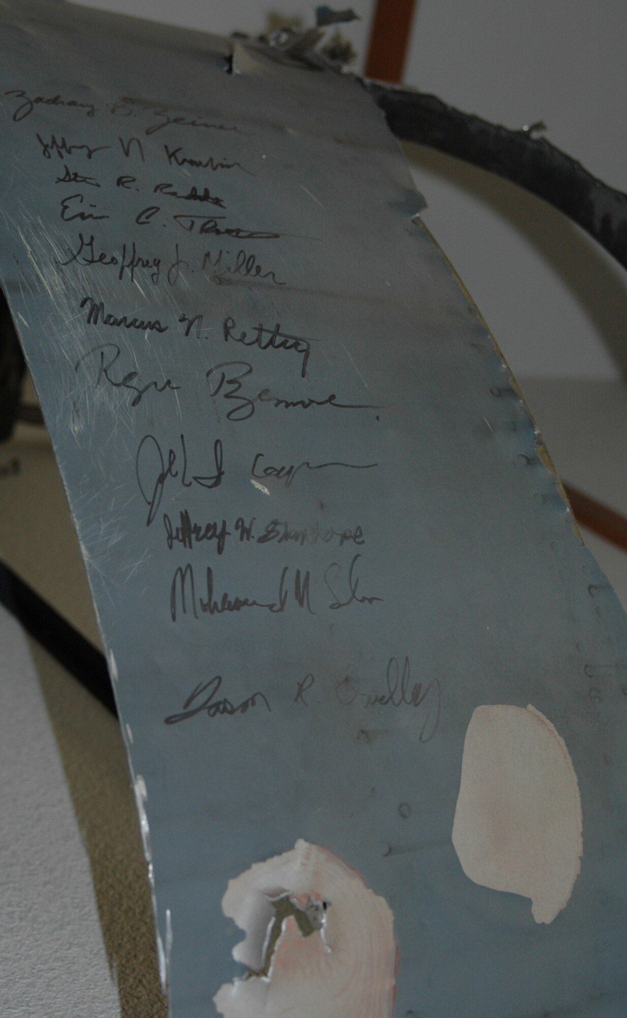 C-5 Galaxy engine cover signed by the 11 crewmembers on board the Jan. 8 2004 flight on display in the 22nd Airlift Squadron building at Travis. (U.S. Air Force photo /Tyler Grimes)