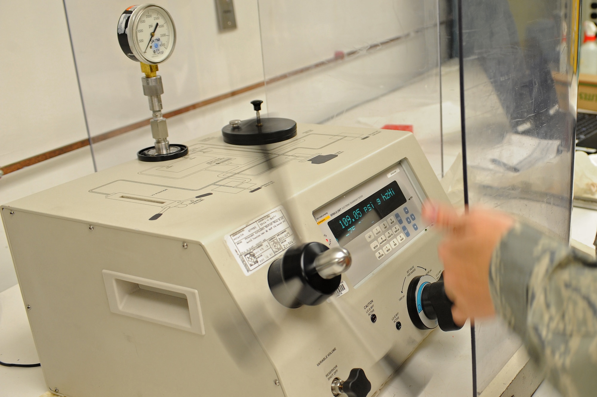 U.S. Air Force Airman 1st Class Sarah Cartmill spins the pressure controller on an electronic deadweight tester in the precision measurement equipment laboratory on Seymour Johnson Air Force Base, N.C., March 28, 2012. The tester calibrates hydraulic gauges and Airmen inspect it every six months for quality assurance. Cartmill, 4th Component Maintenance Squadron test measurement diagnostic equipment technician, hails from Millry, Ala. (U.S. Air Force photo/Airman 1st Class John Nieves Camacho/Released)