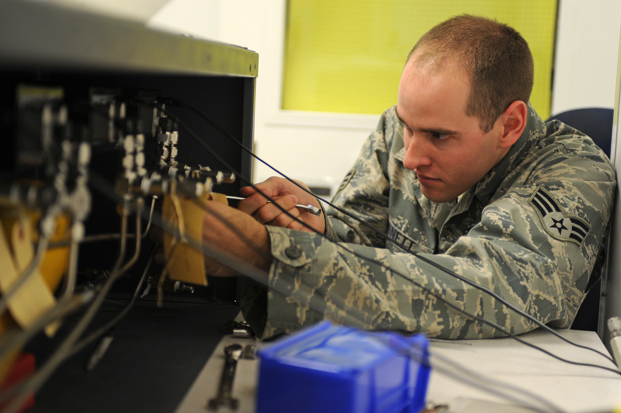 U.S. Air Force Senior Airman Charles Bennett tightens a high pressure fitting on a heiseboard in the precision measurement equipment laboratory on Seymour Johnson Air Force Base, N.C., March 28, 2012. Maintainers use the heiseboard to calibrate a variety of gauges found on fuel trucks, fire trucks and fire suppression systems. Bennett, 4th Component Maintenance Squadron precision calibration technician, hails from Franklin, N.C. (U.S. Air Force photo/Airman 1st Class John Nieves Camacho/Released)