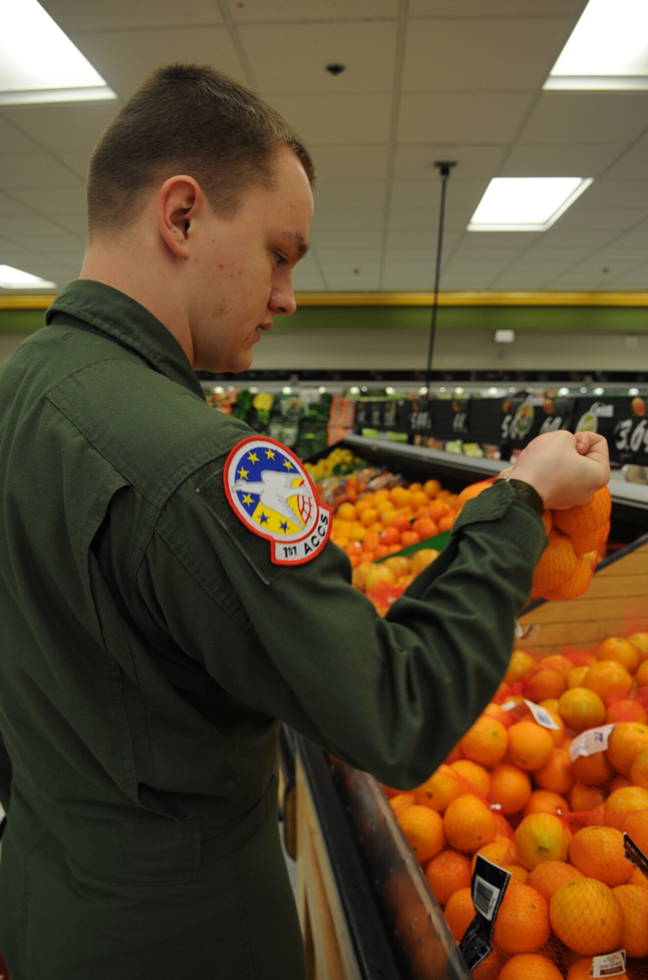 U.S. Air Force Airman 1st Class Sheridan Lacy shops for oranges at the commissary on Seymour Johnson Air Force Base, N.C., March 29, 2012. Lacy gets his daily recommended fruits by consuming two cups of apples and oranges. Lacy is a 1st Airborne Communication Control Squadron data operator from Offutt Air Force Base, Neb. He hails from Temecula, Calif. (U.S. Air Force photo/Airman 1st Class Aubrey Robinson/Released) 