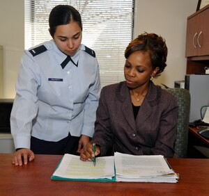 1st Lt. Diana Halferty, left, and Michelle Williams, Joint Base Andrews Sexual Assault Response Coordinators, review documents on March 19 prior to coordinating upcoming Sexual Assault Awareness Month events. (U.S. Air Force photo/Airman 1st Class Lindsey A. Beadle)