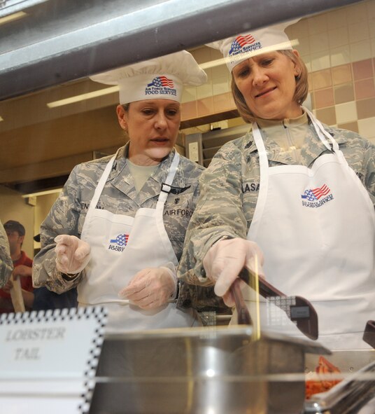Col. Jane Denton, 319th Medical Group commander, and Lt. Col Marie Colasanti, 319th Medical Operations Squadron commander, serve food on March 28, 2012, on Grand Forks Air Force Base, N.D., during an Airmen Appreciation Dinner.  The dinner – which included steak, lobster and chicken cordon bleu - was a chance for the leadership to thank the Airmen for all they do.  (U.S. Air Force photo by Airman 1st Class Xavier Navarro)