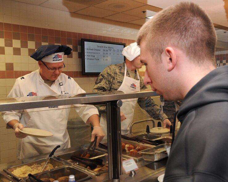 Col. Scott Rizer, 319th Air Base Wing vice commander, serves an Airman chicken cordon blue on March 28, 2012, on Grand Forks Air Force Base, N.D., during an Airmen Appreciation Dinner. The dinner – which included steak, lobster and chicken cordon bleu - was a chance for the leadership to thank the Airmen for all they do.  (U.S. Air Force photo by Airman 1st Class Xavier Navarro)