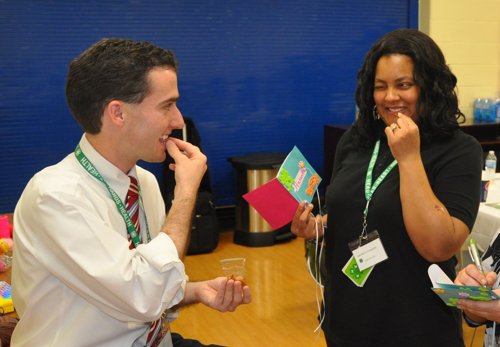 Casey Mull, state military coordinator at the University of Georgia, and Fairchild youth development professional Awanta Edwards,  try meal worms after learning about insects during the skill-a-thon – part of the 4-H “101” training held March 13-16 at Scott Air Force Base, Ill. (U.S. Air Force photo by James L. Hodges)
