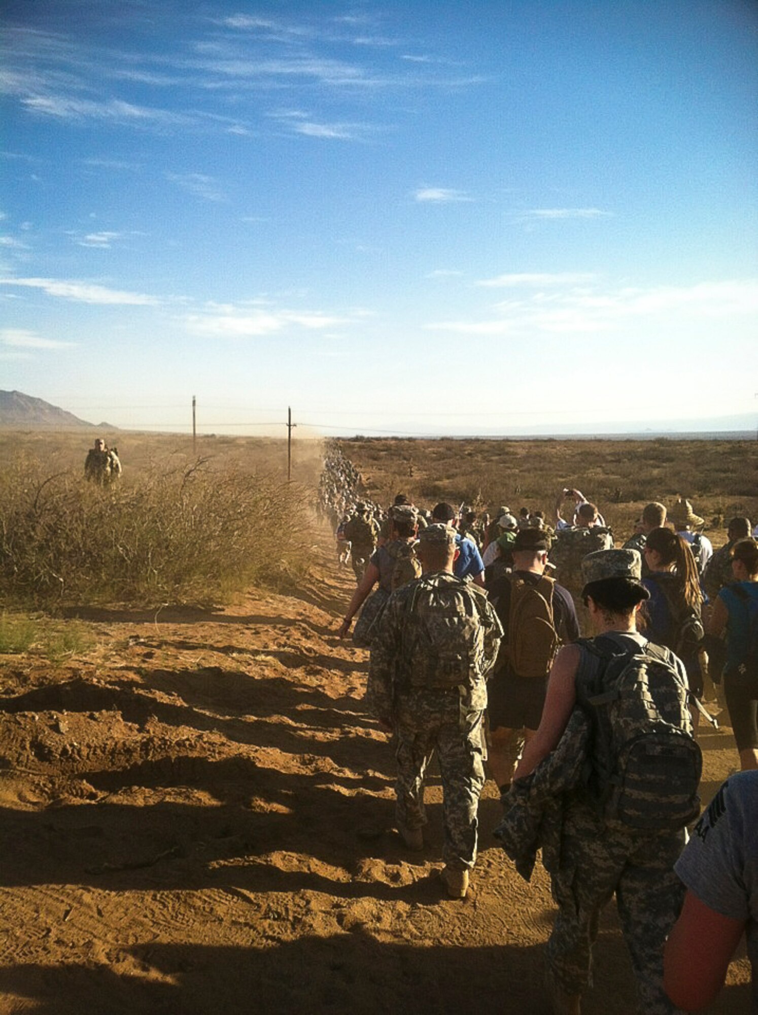 Participants in the White Sands Missile Range Bataan Memorial Death March make their way down the dirt road as part of the 26.2 mile trek March 25 in White Sands, N.M. A JB MDL Soldier participated in the event marking the 70th anniversary of the deadly World War II march. (U.S. Army courtesy photo/Released)