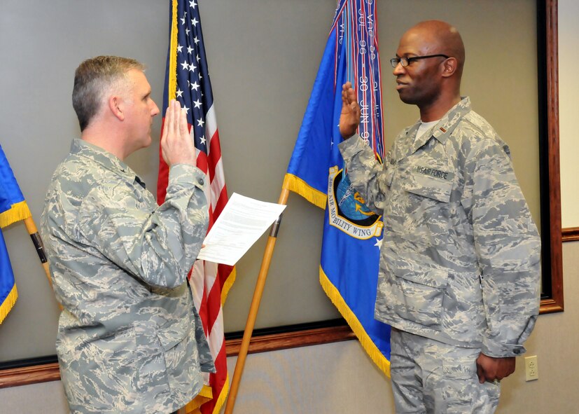TRAVIS AIR FORCE BASE, Calif. -- Brig. Gen. John C. Flournoy, Jr., swears-in 2nd. Lt. Kumuel Bellows during a ceremony here, Mar. 24.  Lt. Bellows is the newest member of the 349th Chaplains staff. (U.S. Air Force photo / Master Sgt. Robert Wade) 