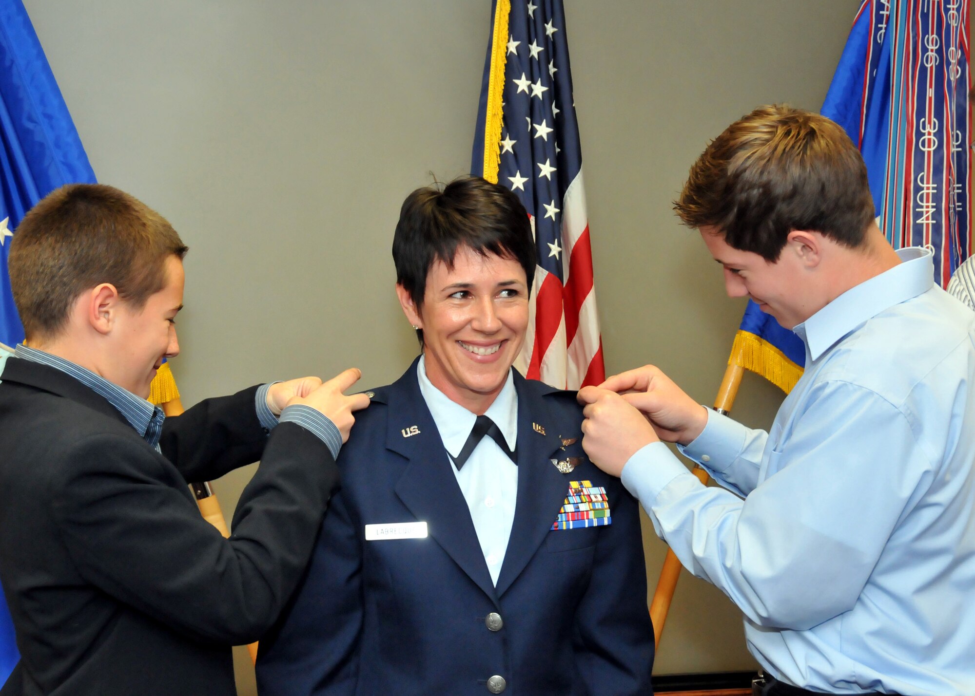 TRAVIS AIR FORCE BASE, Calif. -- Capt. Susan Labrecque is promoted to the rank of Major during a pin-on ceremony here. Maj. Labrecque’s son’s pinned-on her new rank as family and wing members looked on. (U.S. Air Force photo / Master Sgt. Robert Wade) 