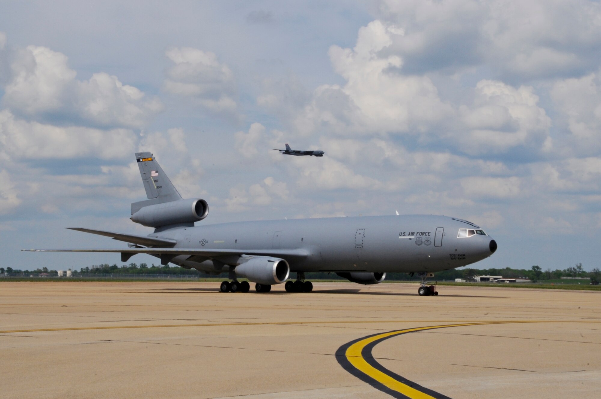 A B-52H Stratofortress flies over KC-10 Extenders on Barksdale Air Force Base, La., March 28. The KC-10s are visiting from Travis AFB, Calif. and McGuire AFB, N.J., to practice in-flight refueling with larger aircraft. (U.S. Air Force photo/Airman 1st Class Micaiah Anthony)(RELEASED)