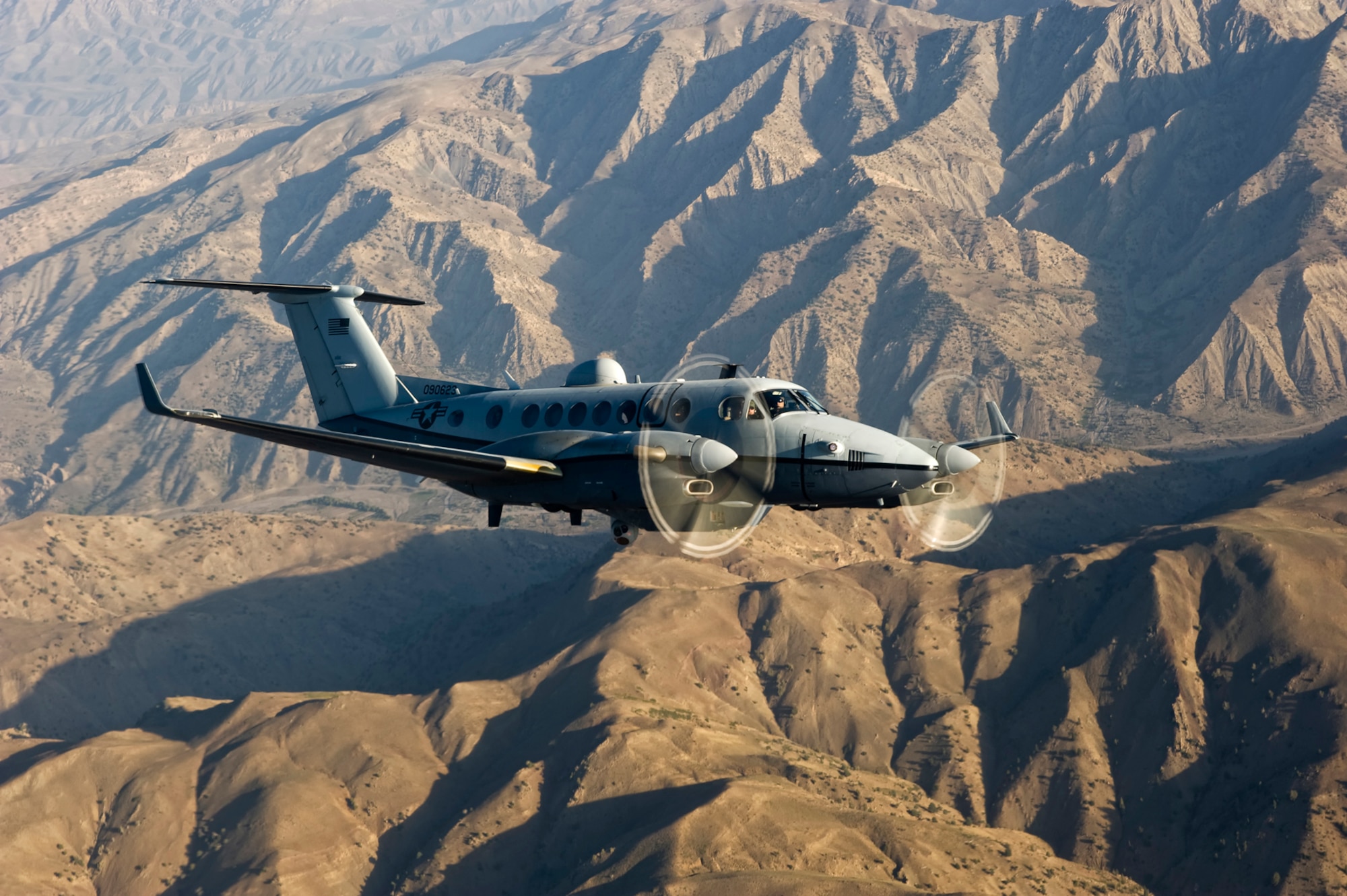 An MC-12 Liberty flies over mountains on a reconnaissance mission. Capt. Robert Madson, 351st Air Refueling Squadron pilot, spent seven months on a deployment, as part of the 4th Expeditionary Reconnaissance Squadron, flying an MC-12 Liberty. Madson supported many Soldiers and special forces Service members, and joint terminal attack controllers, that were his link to the ground forces. (Courtesy photo)