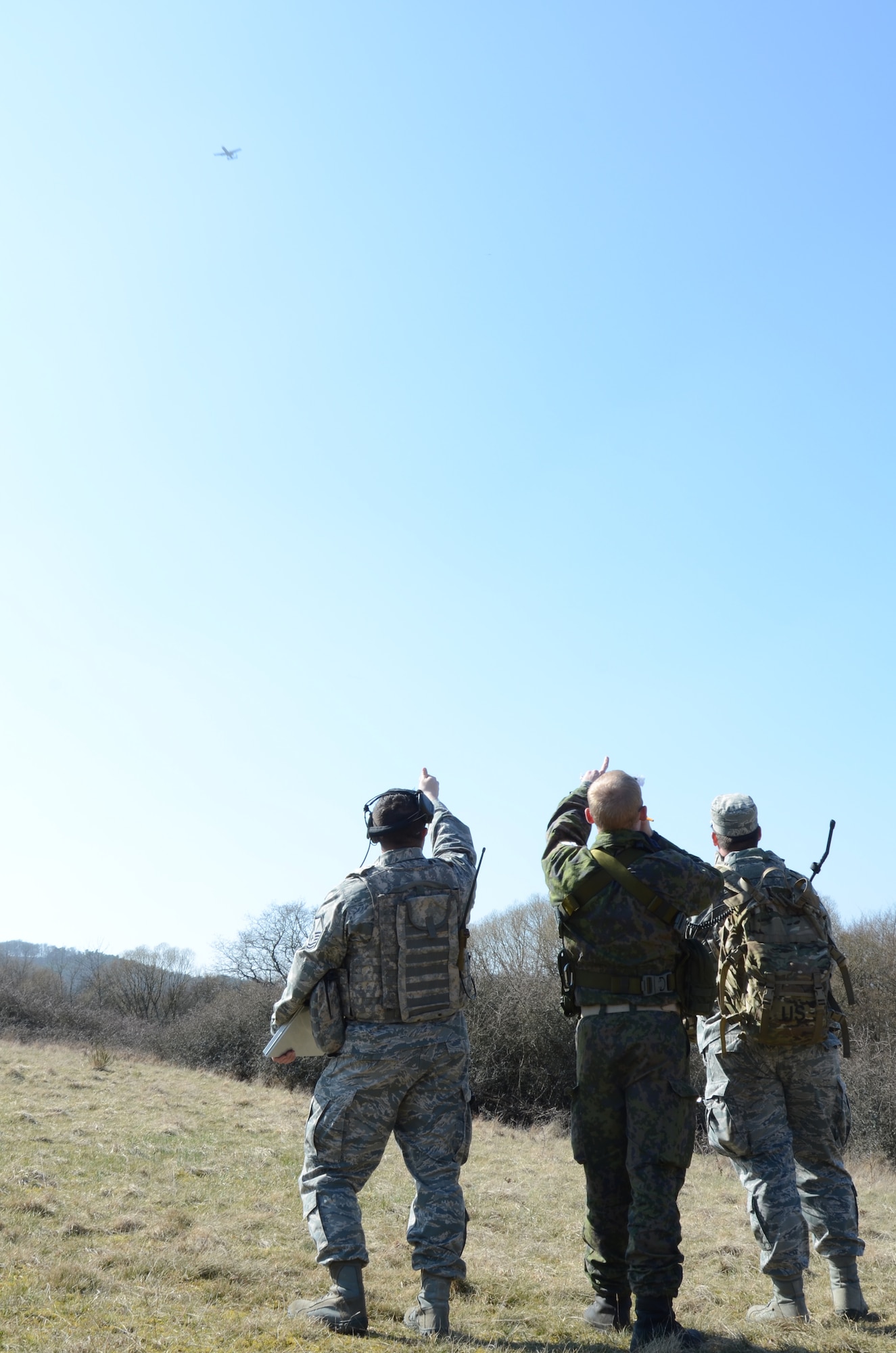 Joint Tactical Air Controller qualification course instructor and two students track the position of an A-10 Warthog flying over a directed target in Baumholder, Germany March 21. Thirteen NATO students graduated the JTACQC at Einsiedlerhof Air Station March 23. (U.S. Air Force photo/ 2nd Lt. Kay M. Nissen)