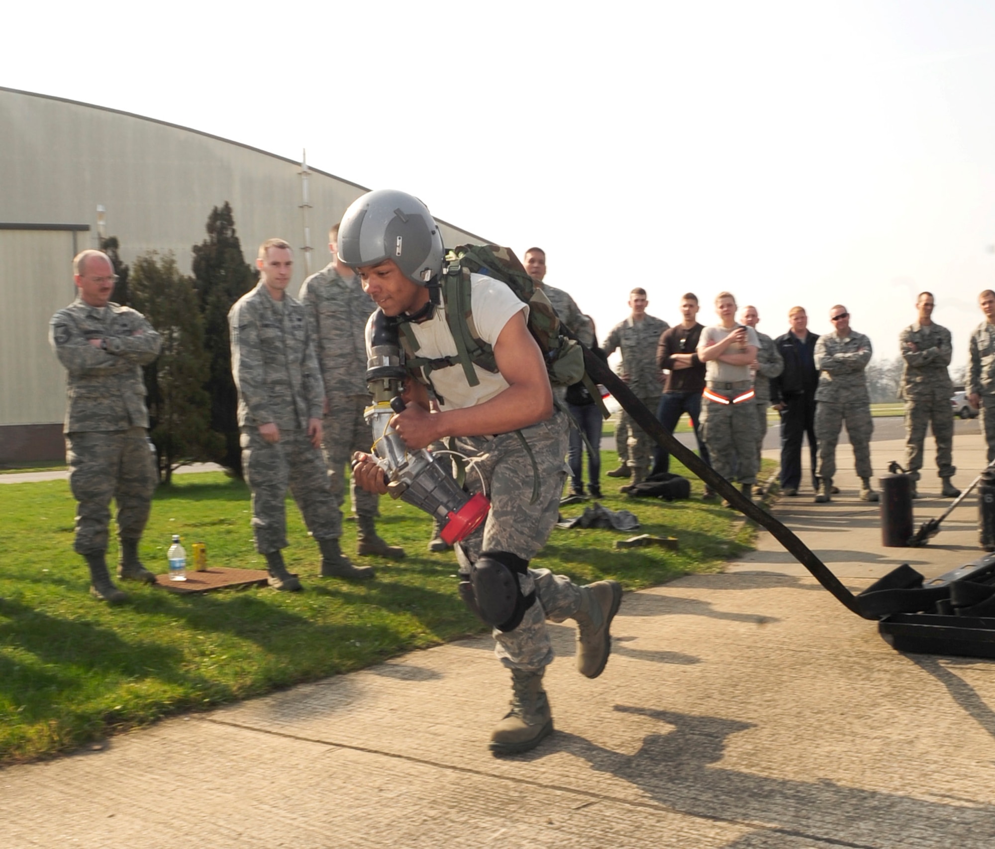 RAF MILDENHALL, England – Airman 1st Class Marcus Green, 100th Logistics Readiness Squadron fuels apprentice, starts the Forward Area Refueling Point qualification course here March 23, 2012. The first challenge of the course required the member to drag a fuel hose out 300 feet while wearing a 45-pound backpack, a flight helmet and knee pads. (U.S. Air Force photo/Senior Airman Ethan Morgan)