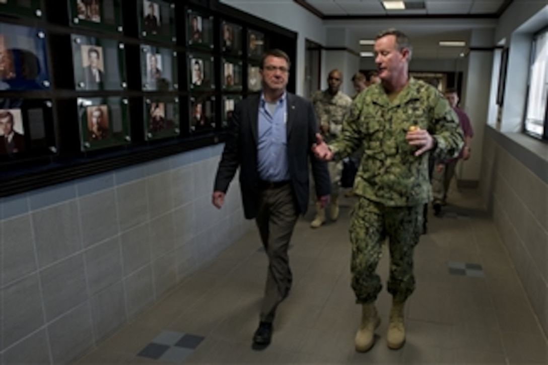 Commander of U.S. Special Operations Command Adm. William H. McCraven escorts Deputy Secretary of Defense Ashton B. Carter through the corridors of Special Operations headquarters at MacDill Air Force Base, Fla., on March 28, 2012.  