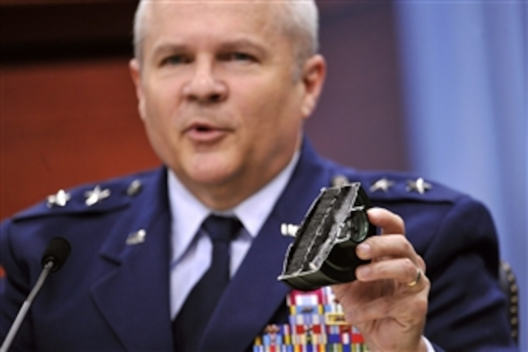 Maj. Gen. Charles Lyon holds up a HEPA filter while talking about the oxygen delivery system of the F-22 Raptor during a briefing for the media on the F-22 Scientific Advisory Board findings in the Pentagon Press Briefing Room on March 29, 2012.  