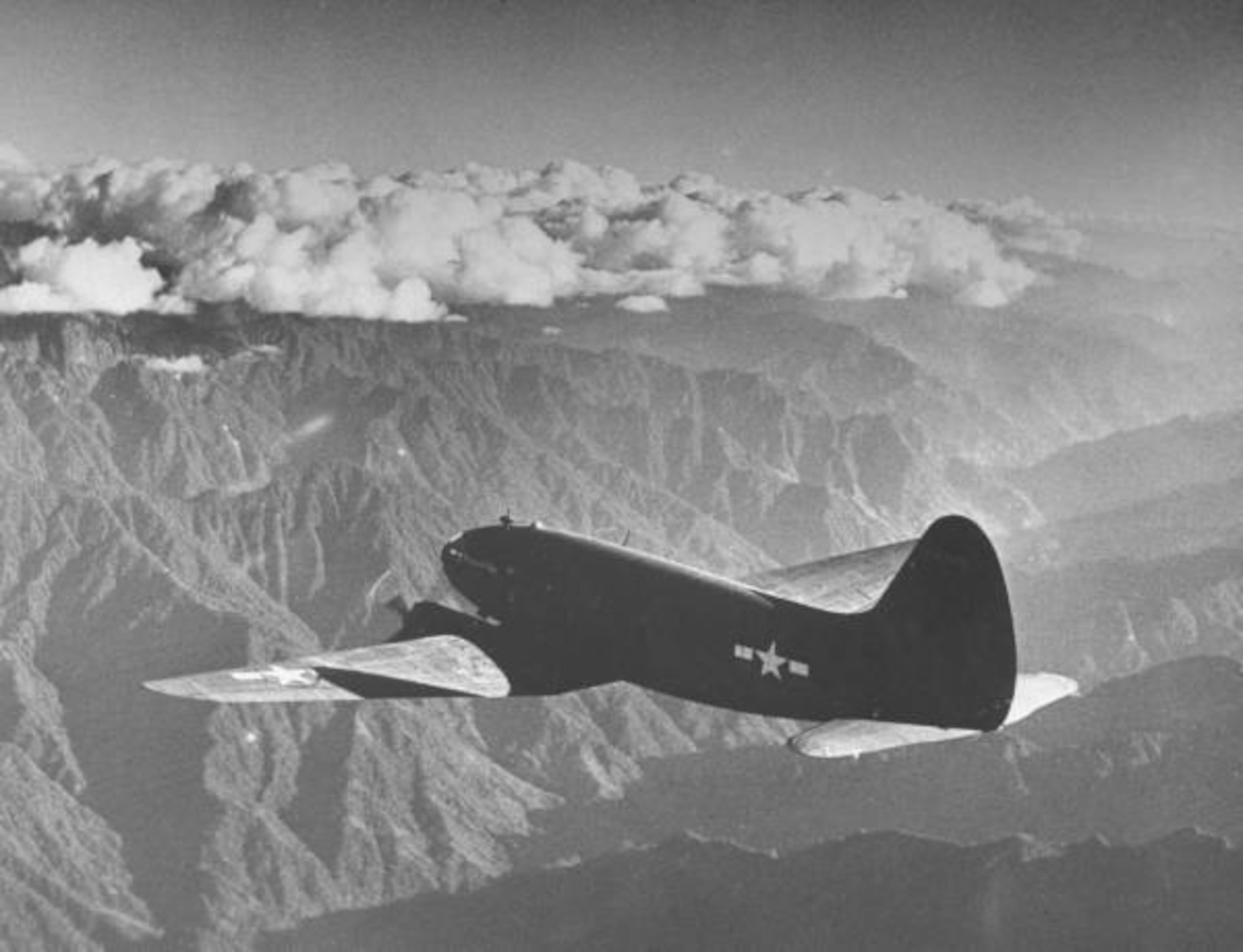 A C-46 Commando flies over “the Hump,” part of the Owen Stanley Mountain Range in New Guinea. Members of the 22nd Airlift Squadron made this trip many times during World War II. (Courtesy photo)