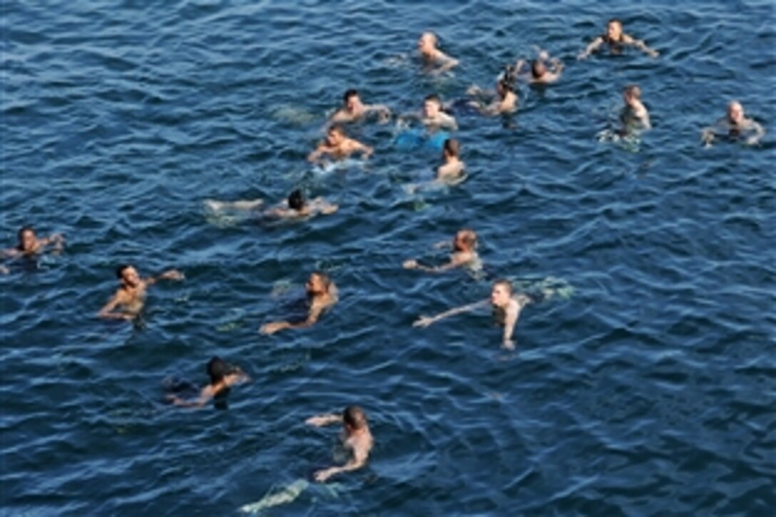 U.S. Navy sailors serving aboard the USS Halsey participate in a swim call in the Arabian Sea, March 25, 2012. The Halsey is the flagship for Combined Task Force 151, a multinational task force that conducts counter-piracy operations on Southern Red Sea, Gulf of Aden, the Somali Basin, the Arabian Sea, and the Indian Ocean. 