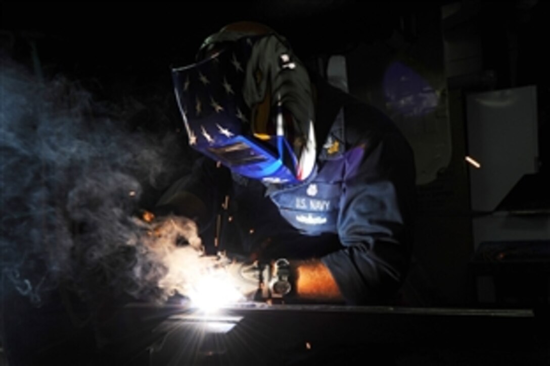 U.S. Navy Petty Officer 1st Class Brian Mouton welds part of the Commodore Oliver H. Perry  cemetery gate in a workshop aboard the Military Sealift Command rescue and salvage ship USNS Grapple, ported at Chaguaramas Coast Guard Base, Trinidad and Tobago, March 28, 2012. The gate Mouton is restoring is from the cemetery where Perry was first buried in 1819, and which was dedicated to him in 1926. Perry was re-interred in Rhode Island in 1826.