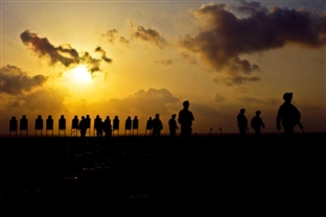 U.S. Marines walk away from training targets after firing small-arms weapons aboard the USS New Orleans under way in the Arabian sea, March 28, 2012. 