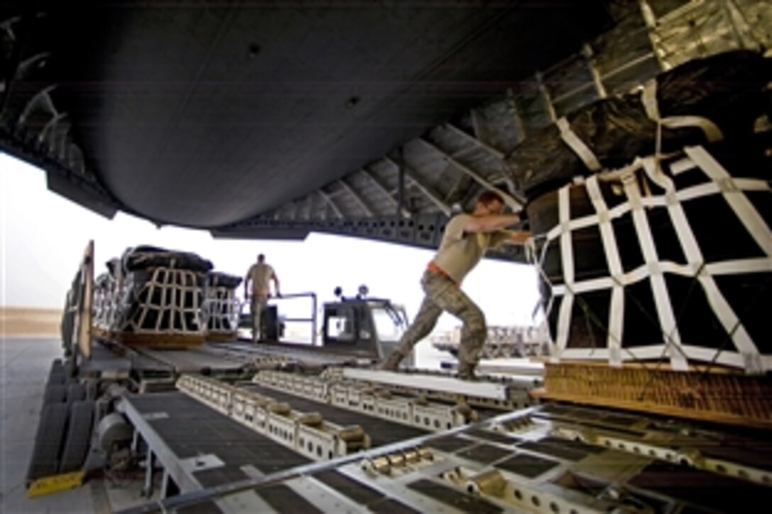 A U.S. Air Force airmen pushes a pallet of jet fuel onto a C-17 Globemaster III aircraft at an undisclosed location in Southwest Asia, March 28, 2012. 
