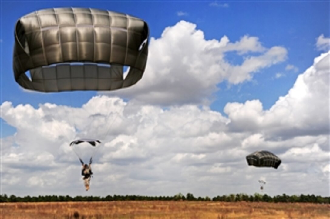 Army and Air Force senior leaders prepare to land after jumping out of an Air Force C-130 Hercules aircraft onto drop zone Normandy on Fort Bragg, N.C., March 22, 2012. 