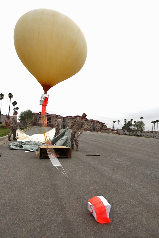 Communications Marines from the 15th Marine Expeditionary Unit, release the Combat SkySat communication system at Camp Pendleton, Calif., March 29, allowing the helium balloon to float to Earth’s stratosphere. The SkySat system is used to retransmit UHF signals to increases the range of communication up to 600 miles in diameter and expands the capabilities of the Marine Air Ground Task Force.::r::::n:: ::r::::n::