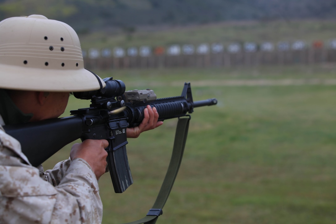Lance Cpl. Peter A. Booth, block NCO at Wilcox Range, demonstraits marksmanship qualification shooting, using a M16A4 Service Rifle and some of the newsest authorized optics and modular attachments for qualification.