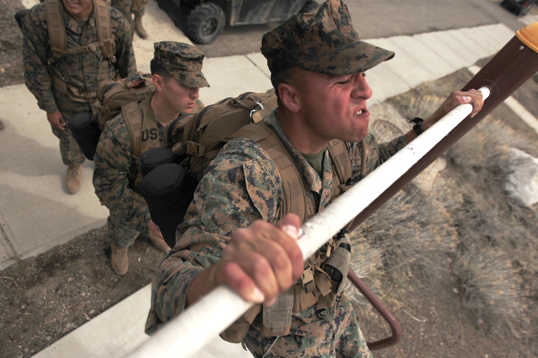 Headquarters and Services Company, 2nd Battalion, 7th Marine Regiment, Marines complete two sets of 20 pull-ups and push-ups, with their gear on after taking a hike in the mountains of Marine Corps Mountain Warfare Training Center Bridgeport March 30, 2012.