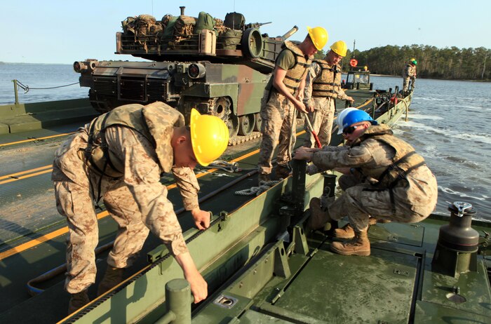 Marines with 8th Engineer Support Battalion, 2nd Marine Logistics Group tie a MKIII Bridge Erection Boat to the side of a raft during an operation aboard Camp Lejeune, N.C., March 30, 2012.  The Marines of Bridge Company, 8th ESB transported 15 vehicles and 48 Marines across the river, which significantly reduced the travel time for 2nd Tank Battalion, 2nd Marine Division.