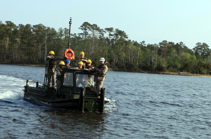 Marines with Bridge Company, 8th Engineer Support Battalion, 2nd Marine Logistics Group ride on a MKIII Bridge Erection Boat while other Marines prepared a raft during an operation aboard Camp Lejeune, N.C., March 30, 2012. Two of these boats push the raft across the water to transport 15 vehicles and 48 passengers in support of a 2nd Tank Battalion, 2nd Marine Division field exercise.