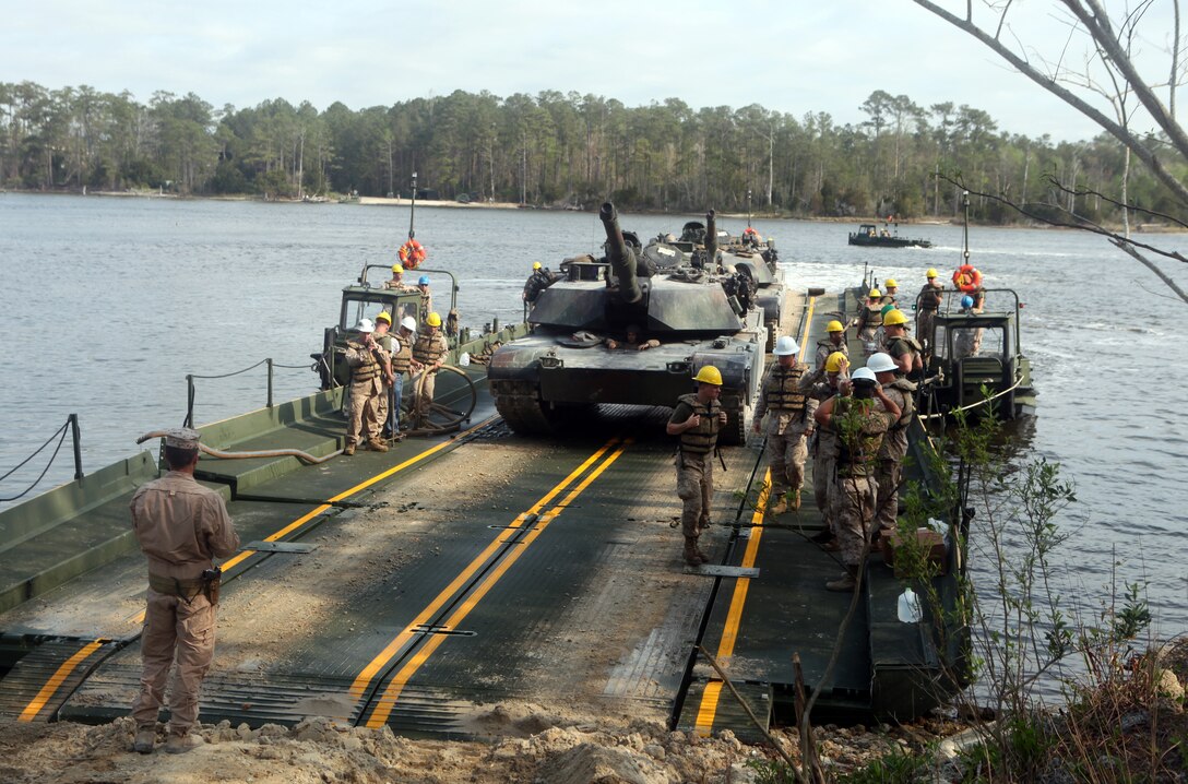Marines with 8th Engineer Support Battalion, 2nd Marine Logistics Group and Marines with 2nd Tank Battalion, 2nd Marine Division unload vehicles after the raft made landfall during an operation aboard Camp Lejeune, N.C., March 30, 2012. The Marines of Bridge Company, 8th ESB used the raft to transport 15 vehicles across the New River to ensure the Marines of 2nd Tank Bn. could complete their mission.