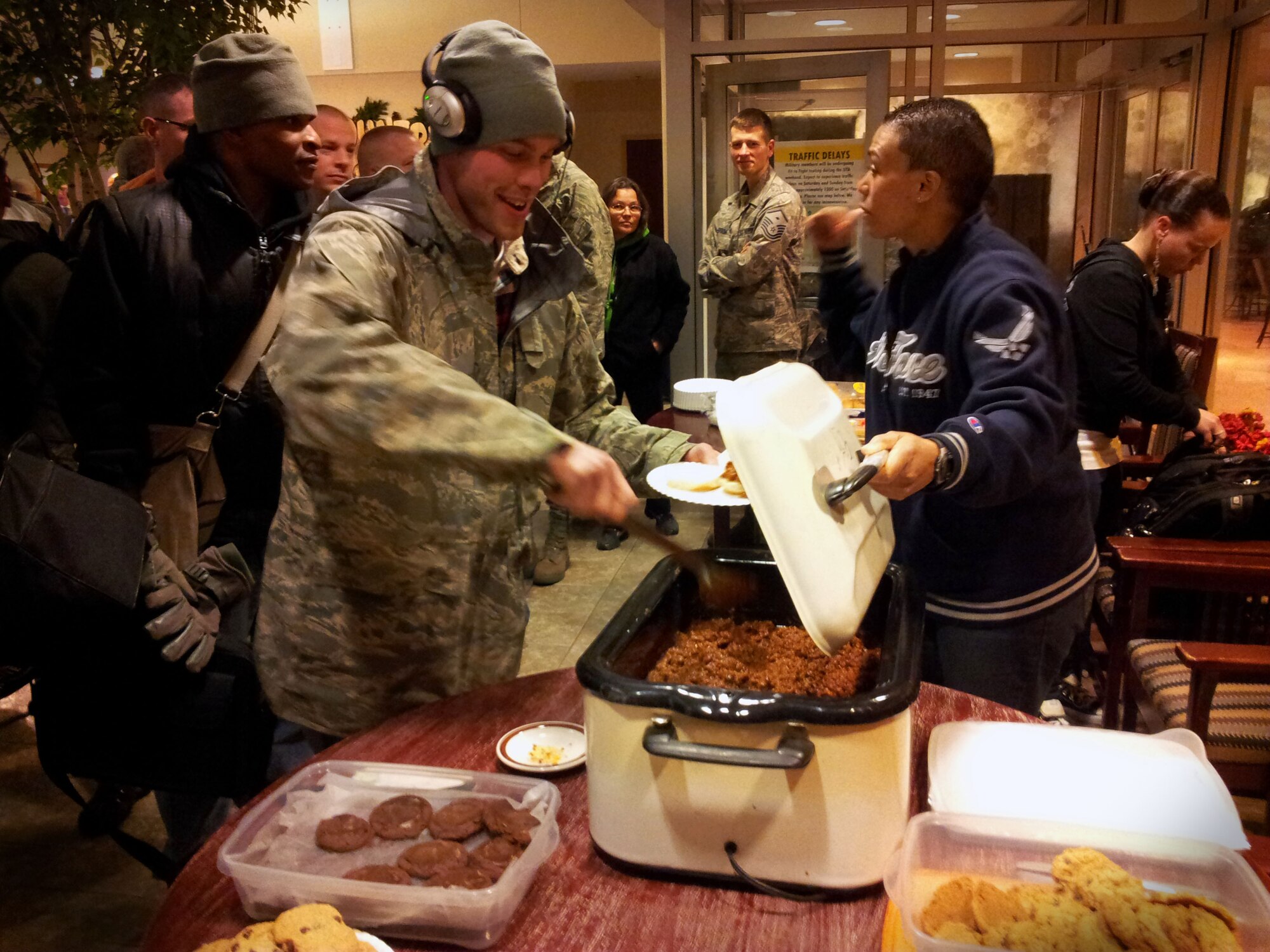 SSgt Kenneth Corry, grabs a sloppy joe after arriving on the Chicago UTA shuttle. The Rising Six, sponsored by the Chiefs association is keeping the tradition of having hot food at lodging for airman when they arrive on Friday nights of the UTA.Minneapolis-St. Paul IAP ARS, Minn.(U.S. Air Force photo by Tech Sgt. Bob Sommer/Released)