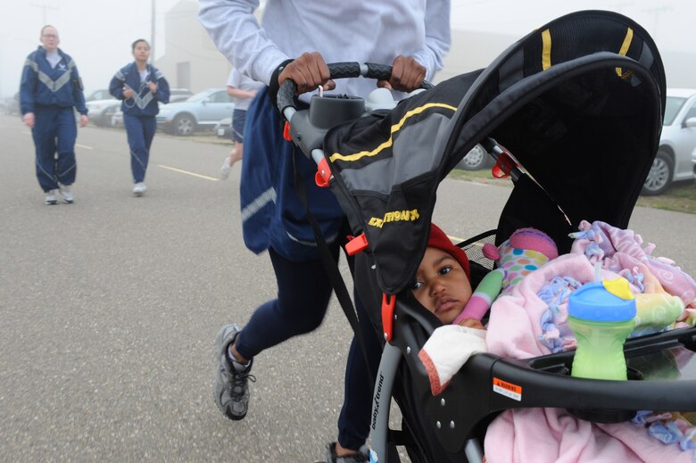 VANDENBERG AIR FORCE BASE, Calif. -- Amyia Hullum, 2-year-old daughter of Senior Airman Brittany Hullum, gets a ride during the monthly Fit-to-Fight Run here Friday, March 20, 2012. Runners were encouraged to wear blue and teal T-shirts, representing Child Abuse Awareness Month and Sexual Assault Awareness Month respectively. Various events will be held for both causes throughout the month, contact the sexual assault response coordinator and family advocacy office for more details. (U.S. Air Force photo/Staff Sgt. Levi Riendeau)
