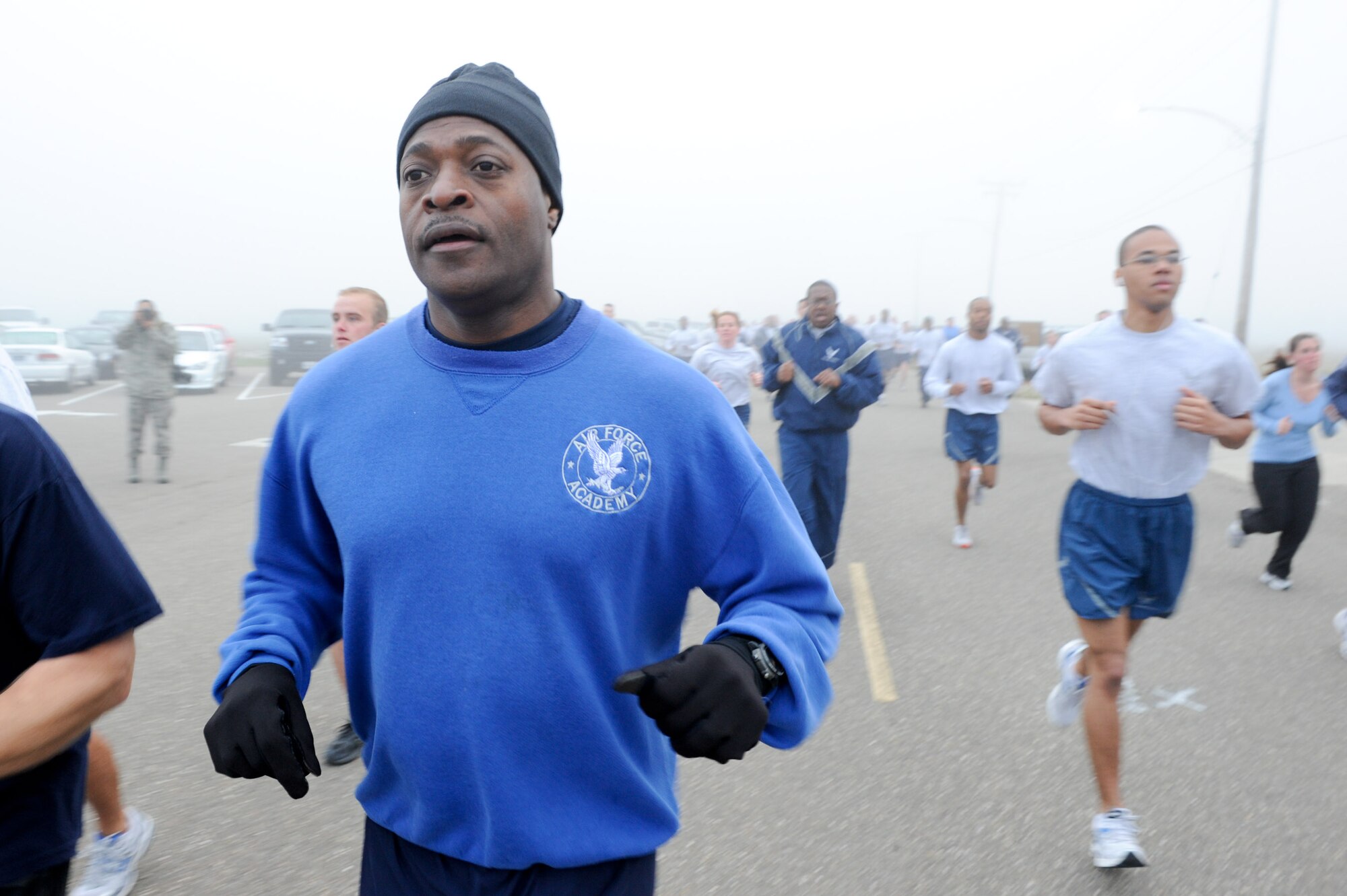 VANDENBERG AIR FORCE BASE, Calif. -- Col. Lavanson Coffey III, the 30th Launch Group commander, jogs during the monthly Fit-to-Fight Run here Friday, March 20, 2012. Runners were encouraged to wear blue and teal T-shirts, representing Child Abuse Awareness Month and Sexual Assault Awareness Month respectively. Various events will be held for both causes throughout the month, contact the sexual assault response coordinator and family advocacy office for more details. (U.S. Air Force photo/Staff Sgt. Levi Riendeau)