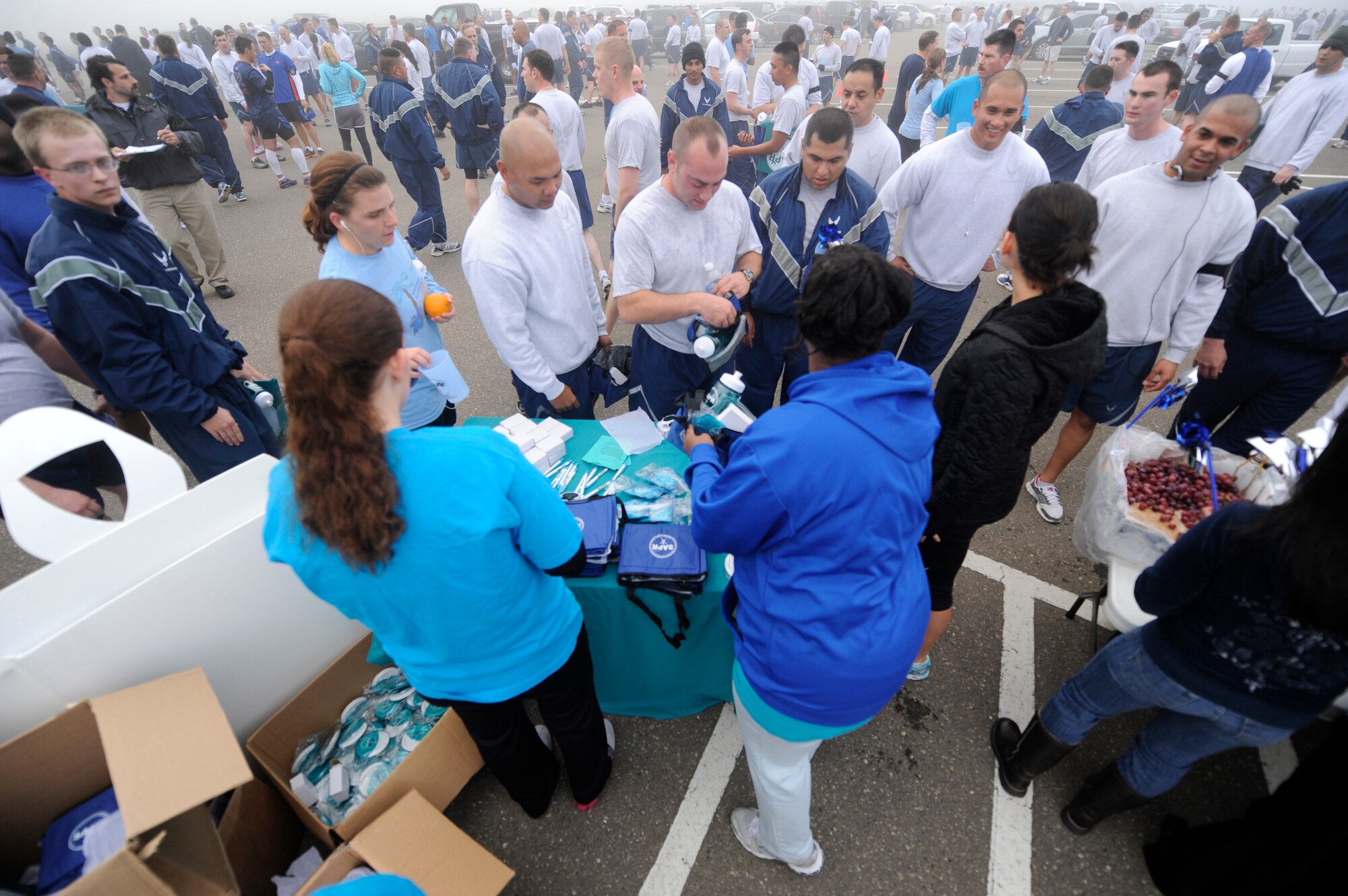 VANDENBERG AIR FORCE BASE, Calif. -- Team V members receive information on sexual assault prevention during the monthly Fit-to-Fight Run here Friday, March 20, 2012. Runners were encouraged to wear blue and teal T-shirts, representing Child Abuse Awareness Month and Sexual Assault Awareness Month respectively. Various events will be held for both causes throughout the month, contact the Sexual Assault Coordinator Response and Family Advocacy office for more details. (U.S. Air Force photo/Staff Sgt. Andrew Satran)
