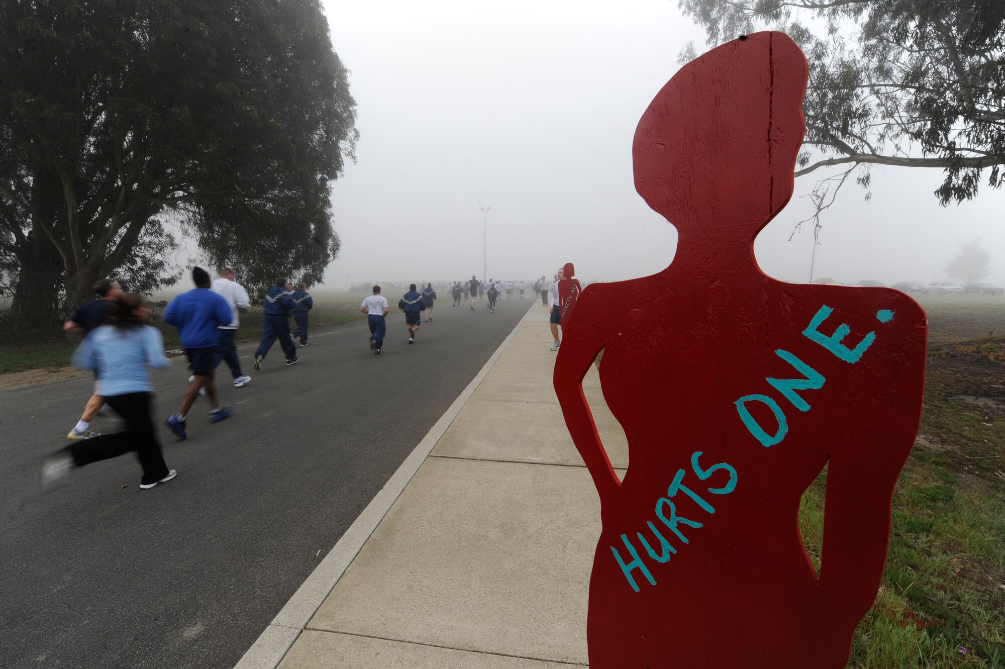 VANDENBERG AIR FORCE BASE, Calif. -- Team V members sprint to the finish line during the monthly Fit-to-Fight Run here Friday, March 20, 2012. Runners were encouraged to wear blue and teal T-shirts, representing Child Abuse Awareness Month and Sexual Assault Awareness Month respectively. Various events will be held for both causes throughout the month, contact the Sexual Assault Coordinator Response and Family Advocacy office for more details. (U.S. Air Force photo/Staff Sgt. Andrew Satran)
