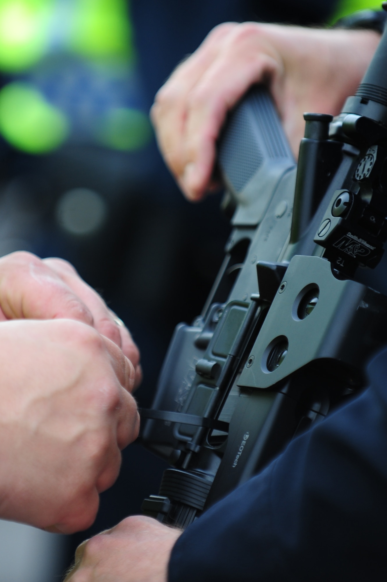 Law enforcement members participating in the Multi Assault Counter Terrorism Action Capabilities training exercise are required to zip-tie all weapons before participating March 28, 2012, at Nellis Air Force Base, Nev. Weapons that are zip-tied cannot perform trigger, hammer or any other action that could discharge the weapon. (U.S. Air Force photo by Staff Sgt. William P.Coleman)
  

