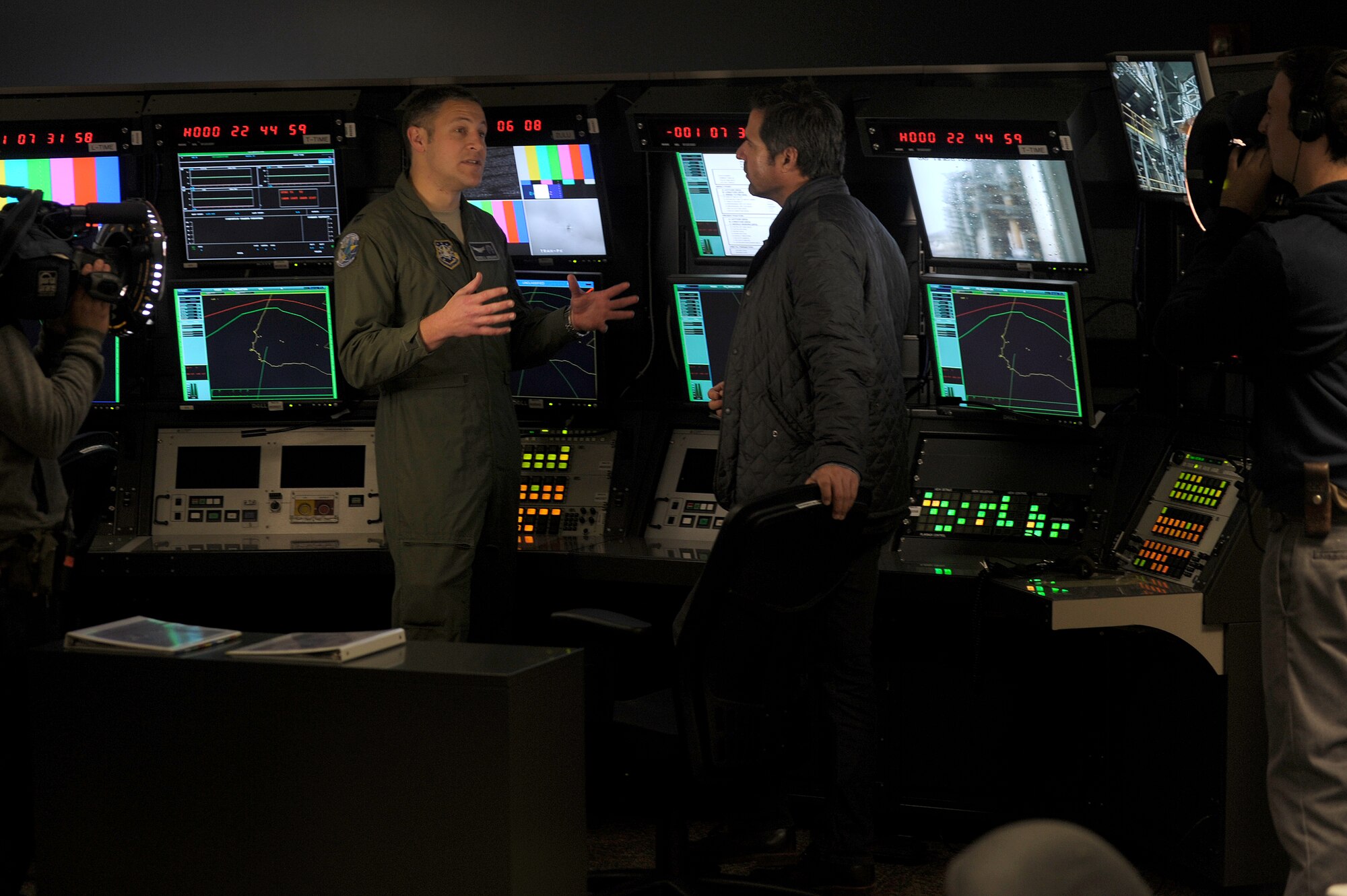 VANDENBERG AIR FORCE BASE, Calif. -- Capt. Pierre Gregoire, 2nd Range Operations Squadron operations flight commander, talks to Don Wildman, television host for the Travel Channel's show Off Limits, about range safety at the Western Range Operations Control Center here March 30, 2012. The WROCC was featured to demonstrate how the Air Force launches rockets safely. (U.S. Air Force photo/Staff Sgt. Andrew Satran) 

