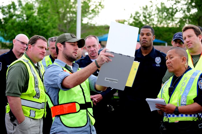 Kenneth Pereira, 99th Security Forces Squadron instructor supervisor, briefs local law enforcement members on the Multi Assault Counter Terrorism Action Capabilities training exercise March 28, 2012, at Nellis Air Force Base, Nev. Mr. Pereira said the exercise showed "the hard work, quality training, and team work our men and women of the 99th Security Forces Squadron have accomplished and will continue to maintain." (U.S. Air Force photo by Staff Sgt. William P.Coleman)  
