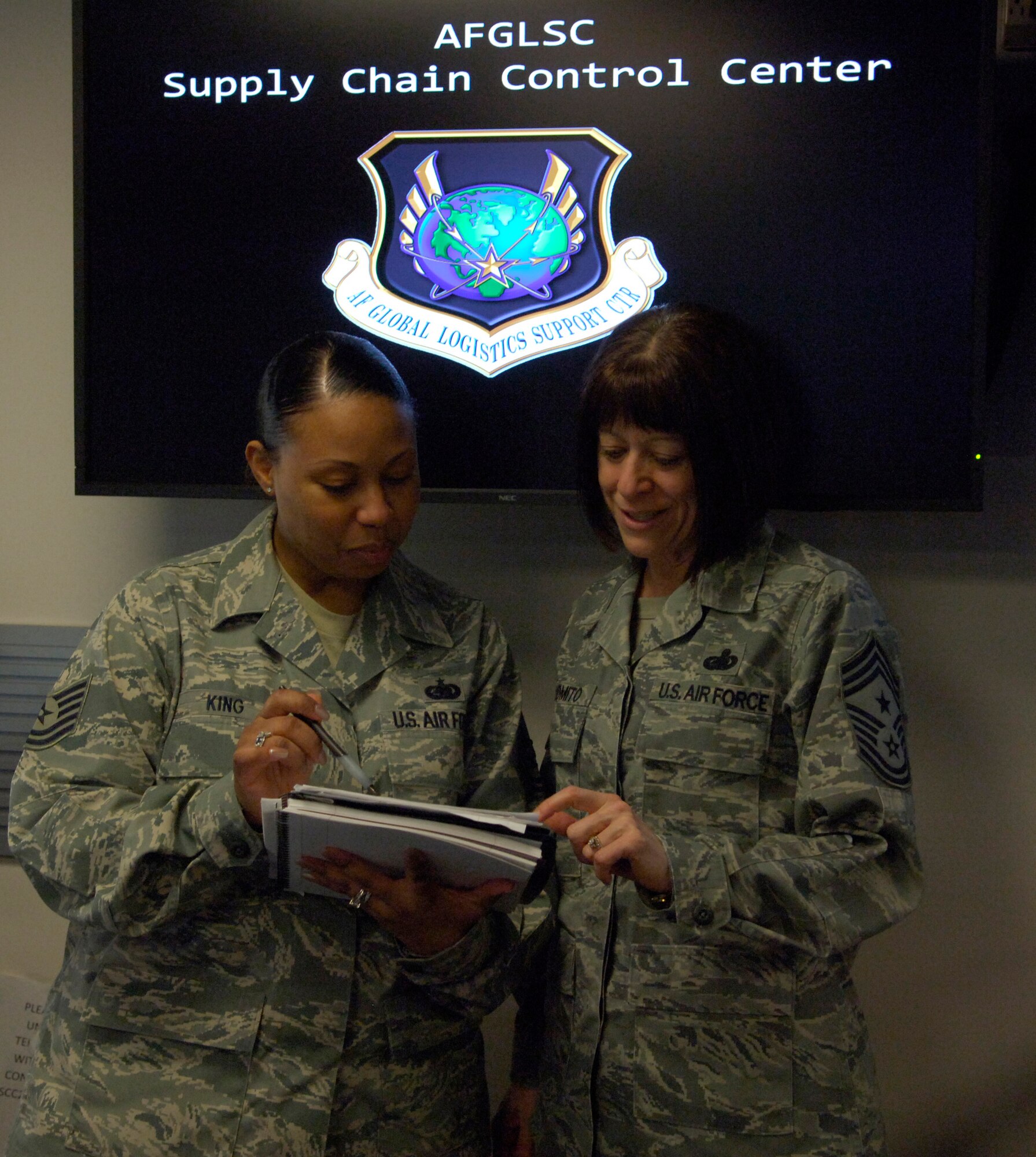 Tech. Sgt. Pamela King, 635th Supply Chain Operations Wing, and Chief Master Sgt. Cynthia Solomito, Air Force Global Logistics Support Center, discuss education at the AFGLSC recently. Solomito is currently working on a dual Master's of Science Degree in Human Resource Development and Management and Leadership. (U.S. Air Force photo by Senior Airman Amber R. Kelly-Herard) 
