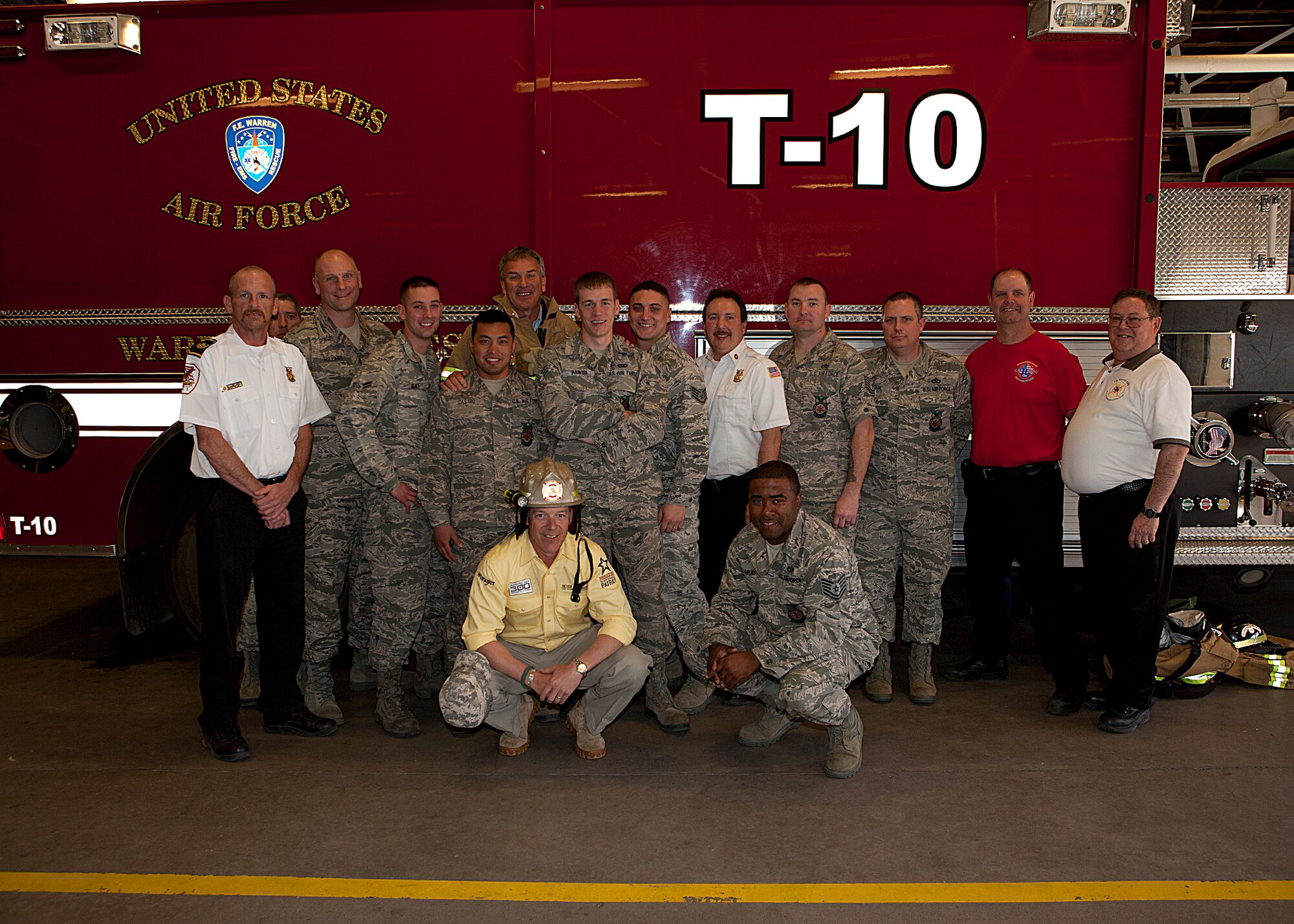 Members of the 90th Civil Engineer Squadron Fire Department pose for a photograph March 23 with American300 founder Robi Powers and Tom Whittaker, the first amputee to summit Mt. Everest. (U.S. Air Force photo by Matt Bilden)
