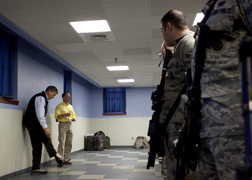 Tom Whittaker, the first amputee to summit Mt. Everest, displays his prosthetic leg while American300 founder Robi Powers speaks with 90th Security Forces Group personnel during guard mount March 23. (U.S. Air Force photo by Matt Bilden)