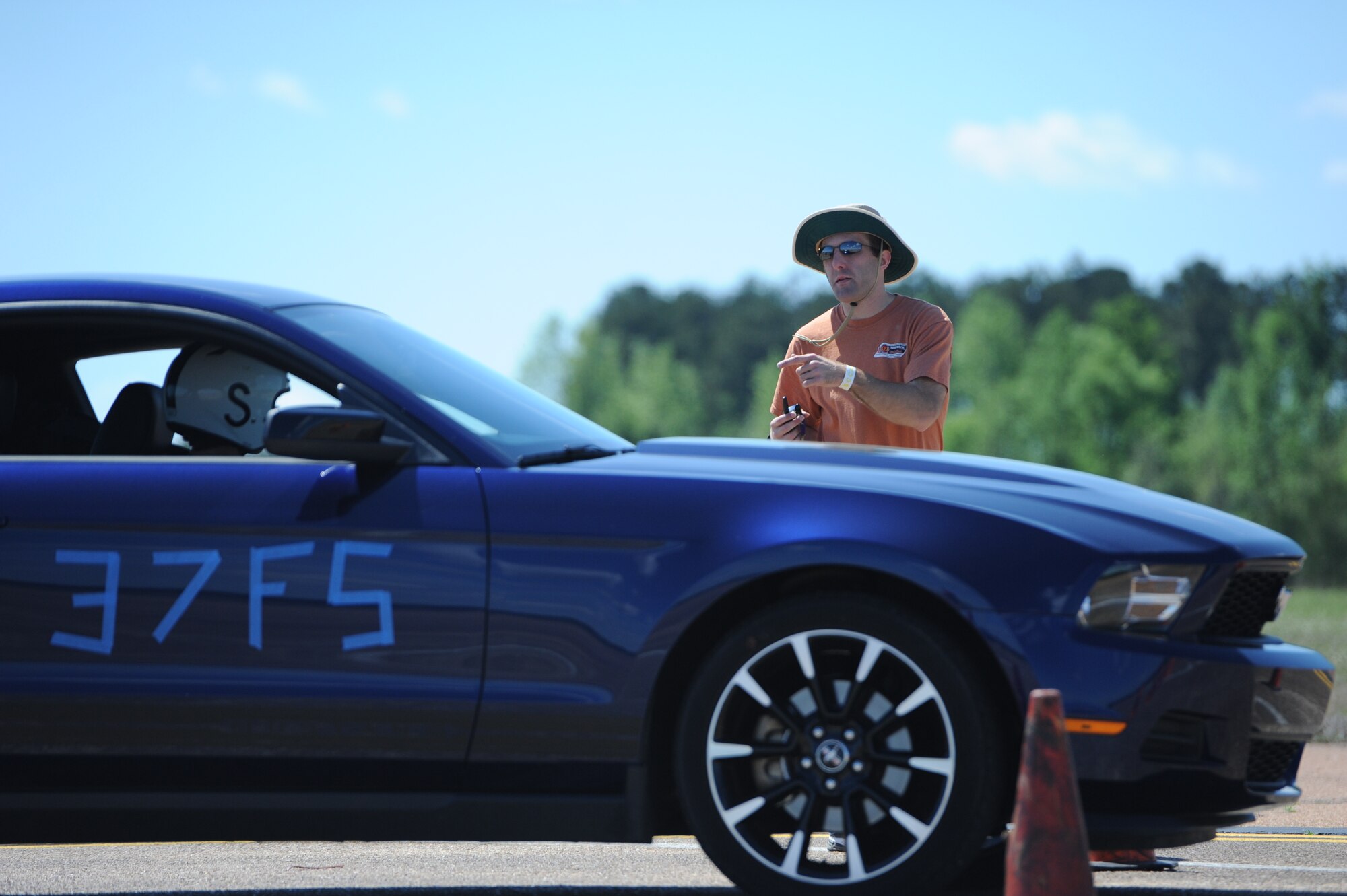 Chris Becker tells Wesley Haney the track is clear for him to start his time trial race during the Sports Car Club of America Solo II autocross March 24 on the Columbus Air Force Base Strategic Air Command ramp.  The SCCA is an organization that allows the public to participate in automobile races on closed courses so that they can get the feel of speed and competition similar to professional car drivers.  For more information visit http://www.scca.com/.  (U.S. Air Force Photo/Airman 1st Class Charles Dickens)