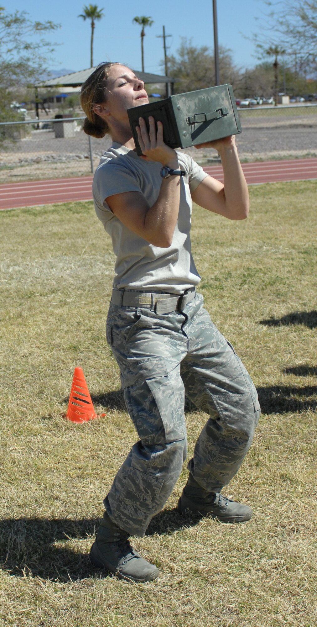U.S. Air Force 2nd Lt. Michele Ernest, 355th Civil Engineer Squadron, lifts a box of ammunition at the Benko Fitness Center track on Davis-Monthan Air Force Base, Ariz., March 23. Ernest was a contestant in the Marine Challenge, a contest sponsored by Benko in which participants completed the U.S. Marine Corps Maneuver Under Fire course. (U.S. Air Force photo by Airman 1st Class Saphfire Cook/Released)